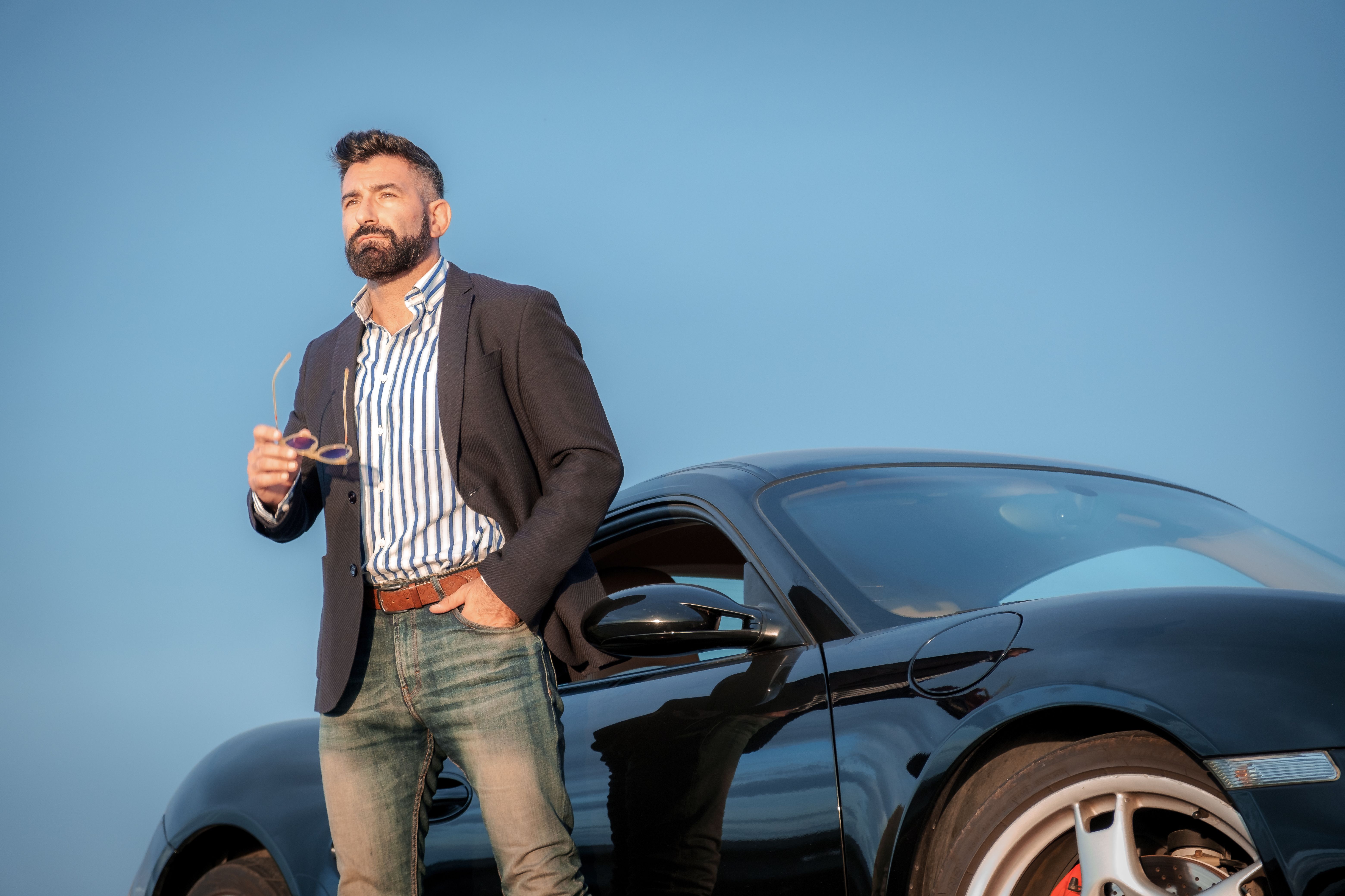 handsome elegant male next to his sports car 2025 02 05 04 30 30 utc